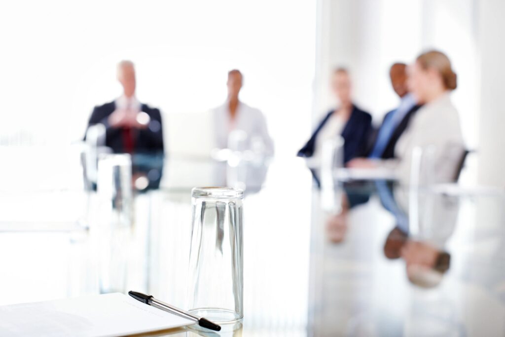 Conference Table With Business People Sitting in the Background
